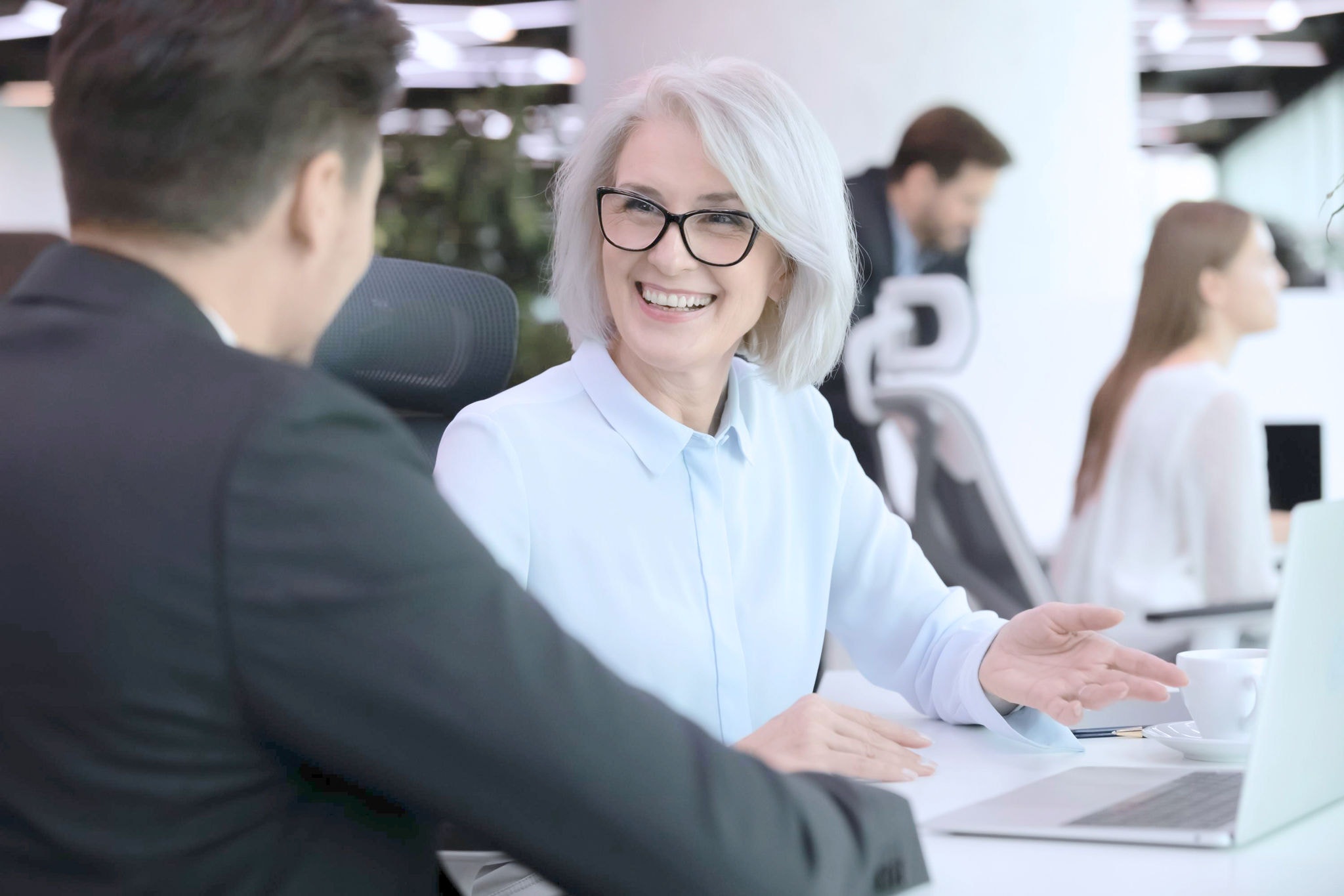 Staff members smiling at each other 