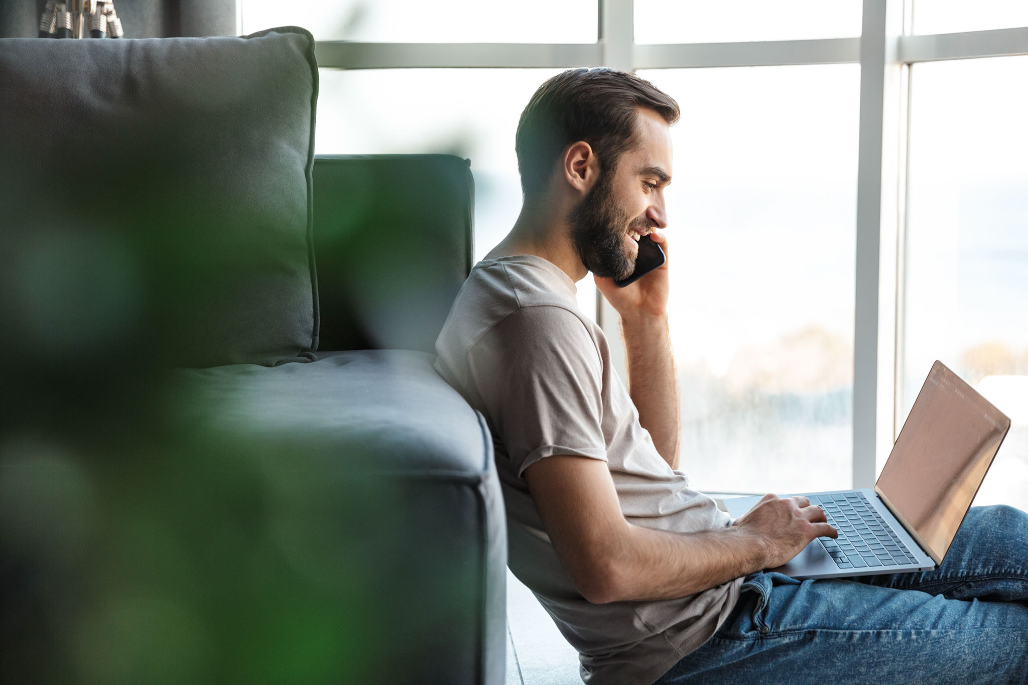 Young man working on the floor talking on his phone