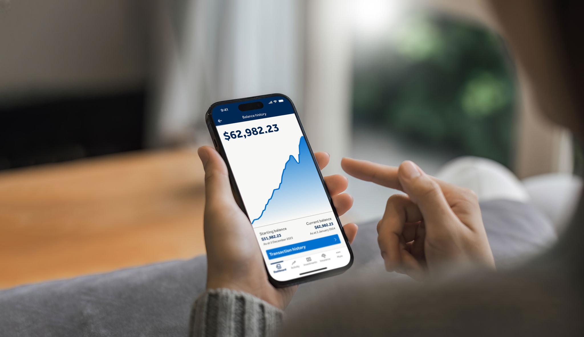 Person holding a phone with the Hostplus App displaying.