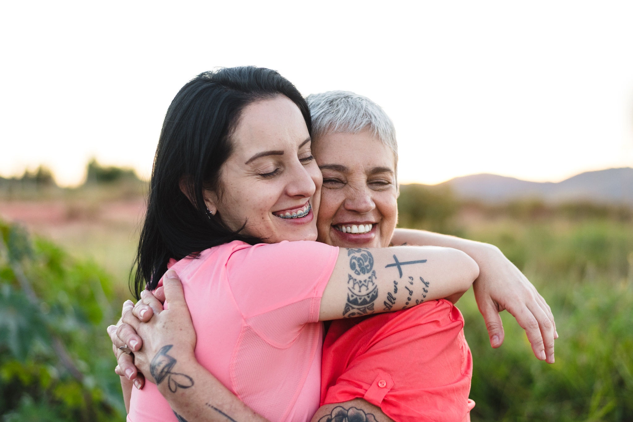 Mother and daughter hugging outdoors