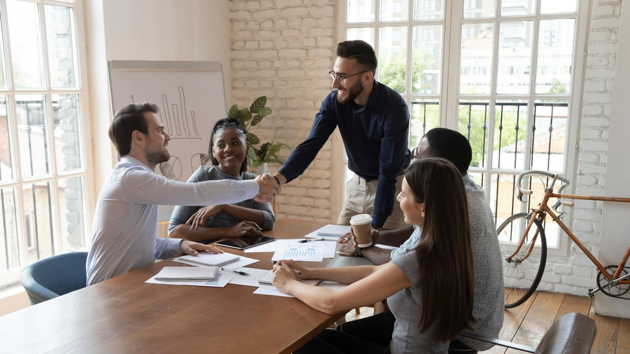 Group of business colleagues shaking hands