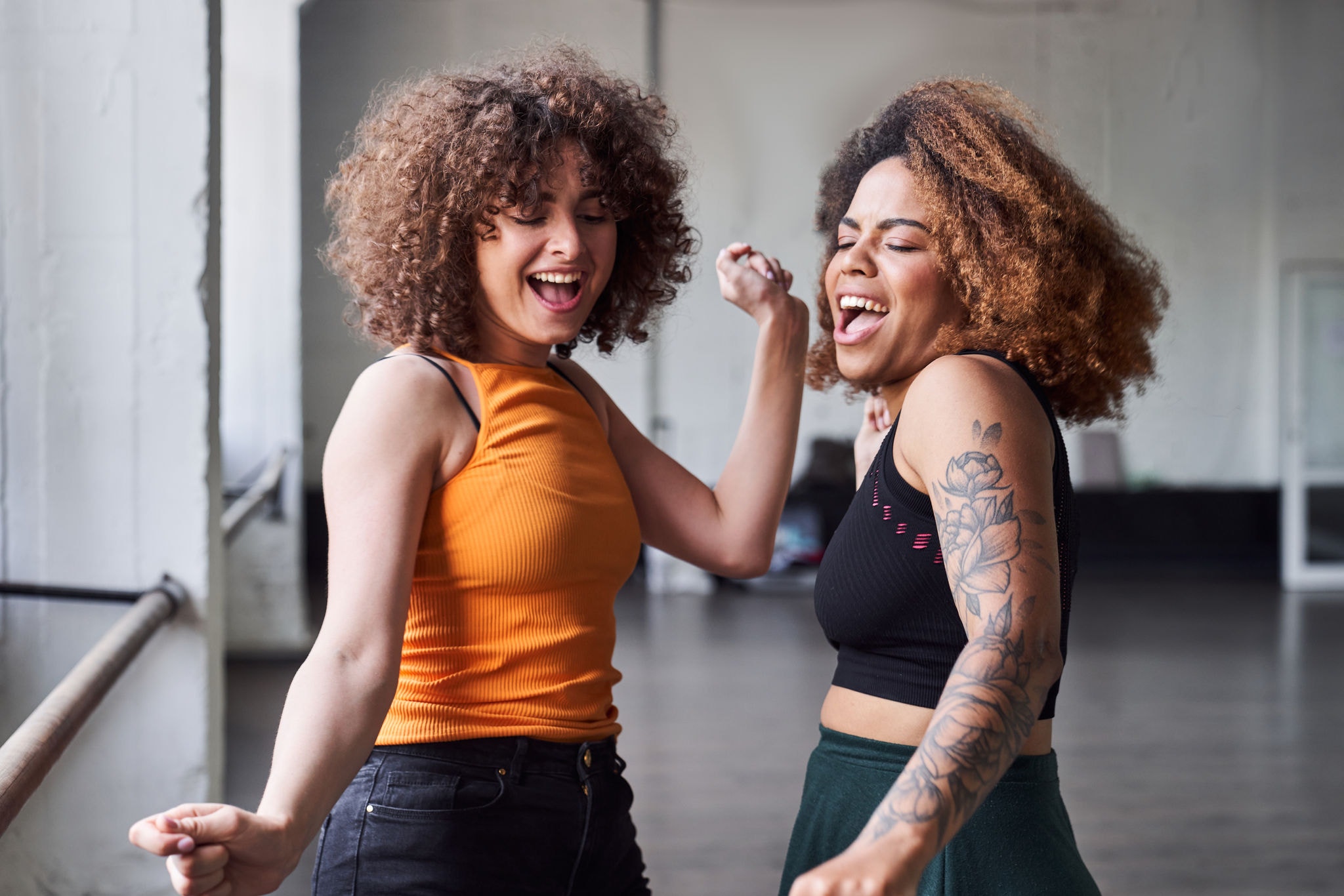 Wasit up of smiling attractive young women dancing and singing a song