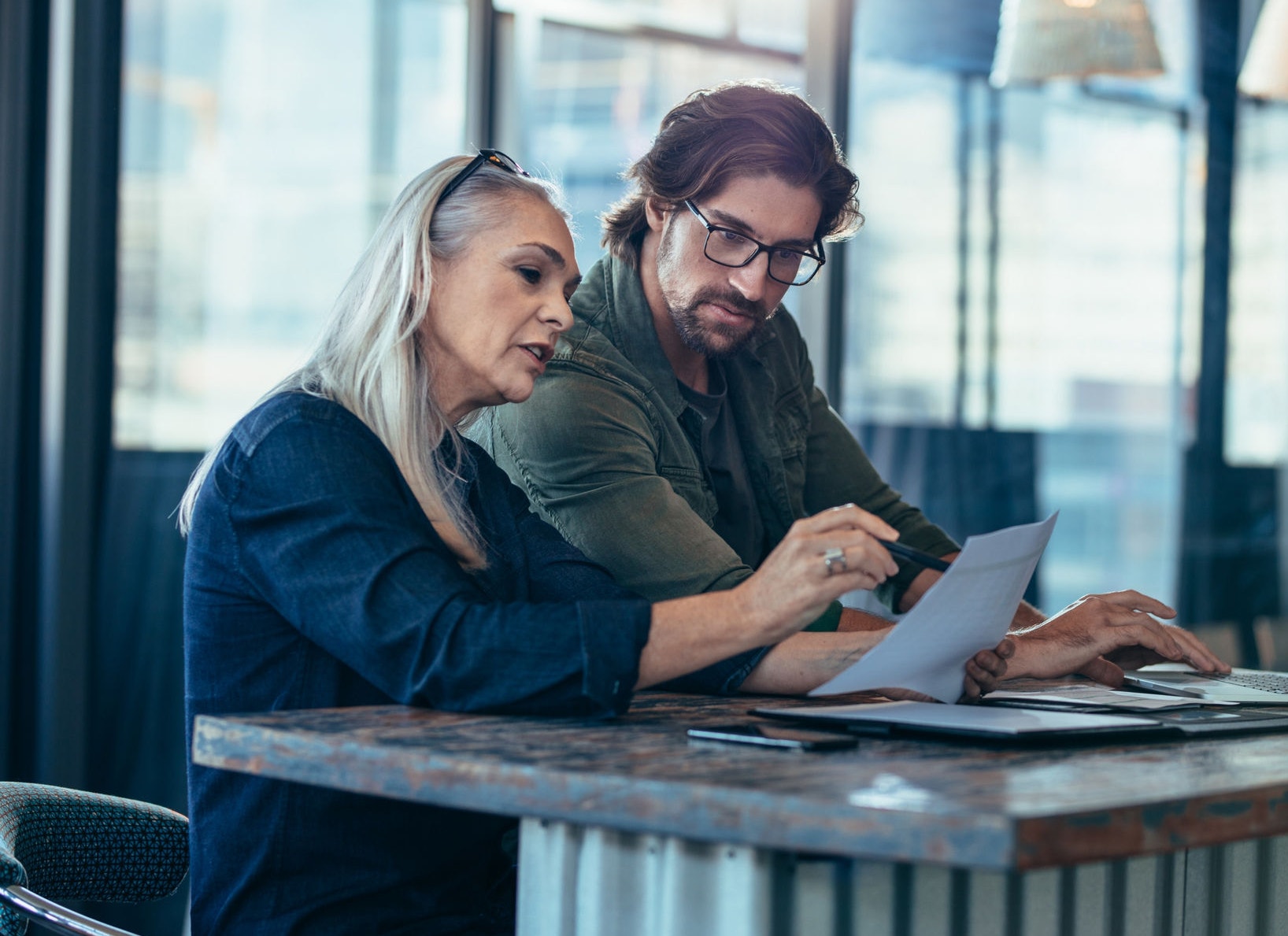 Colleagues talking over business report