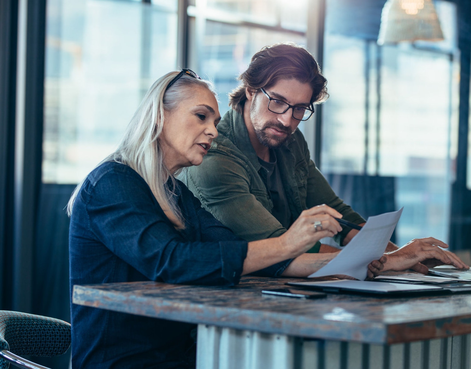Colleagues talking over business report