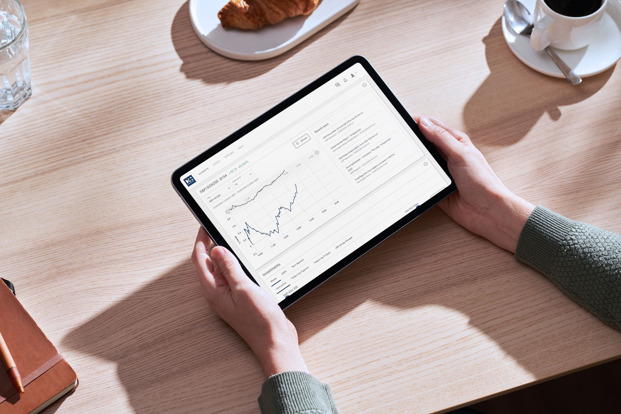 Member at a cafe looking at Hostplus website on their tablet