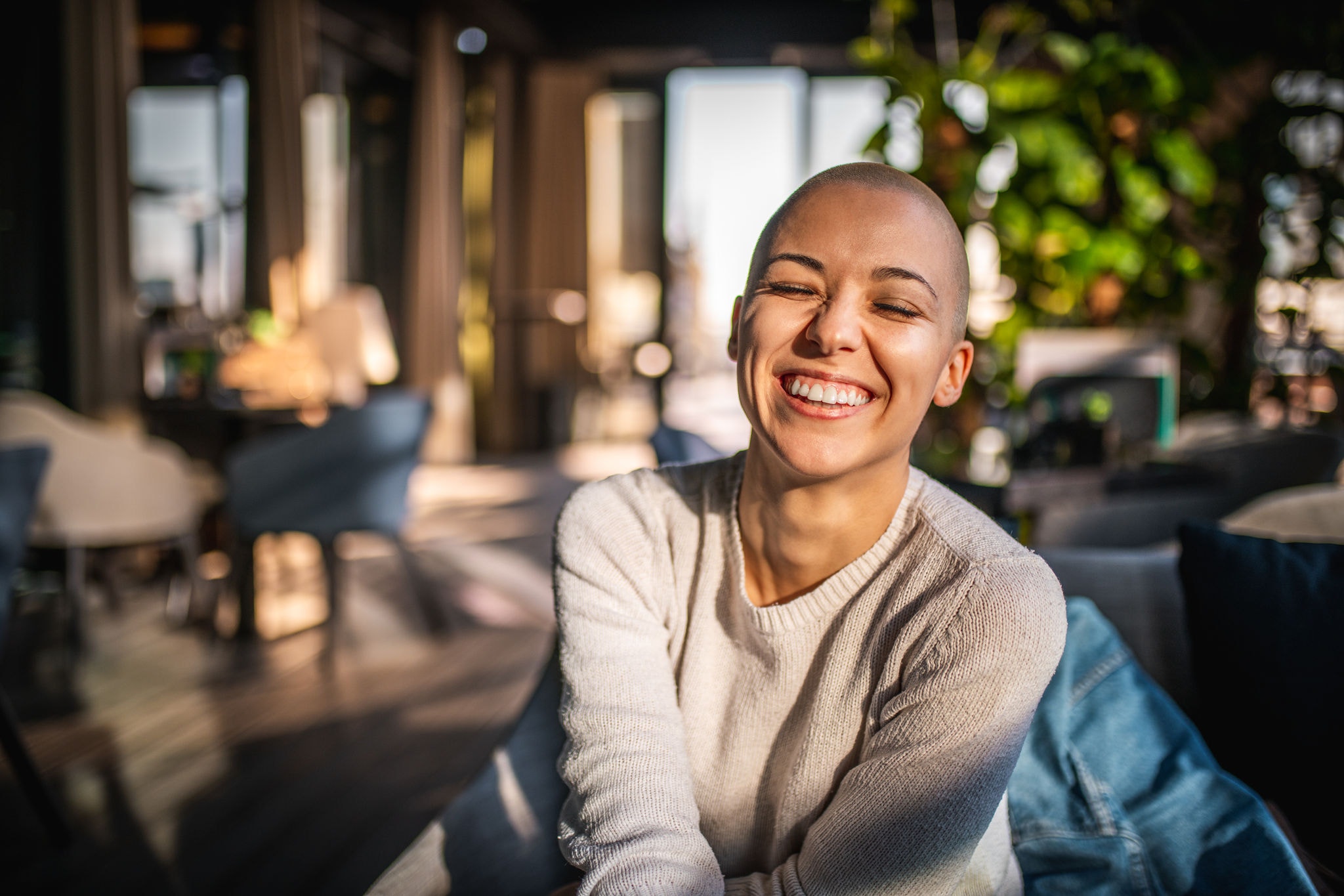 Portrait of a smiling girl with short laughing with her eyes closed
