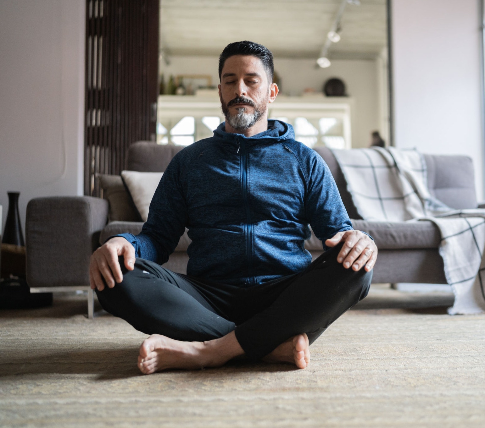 Mature man meditating at home