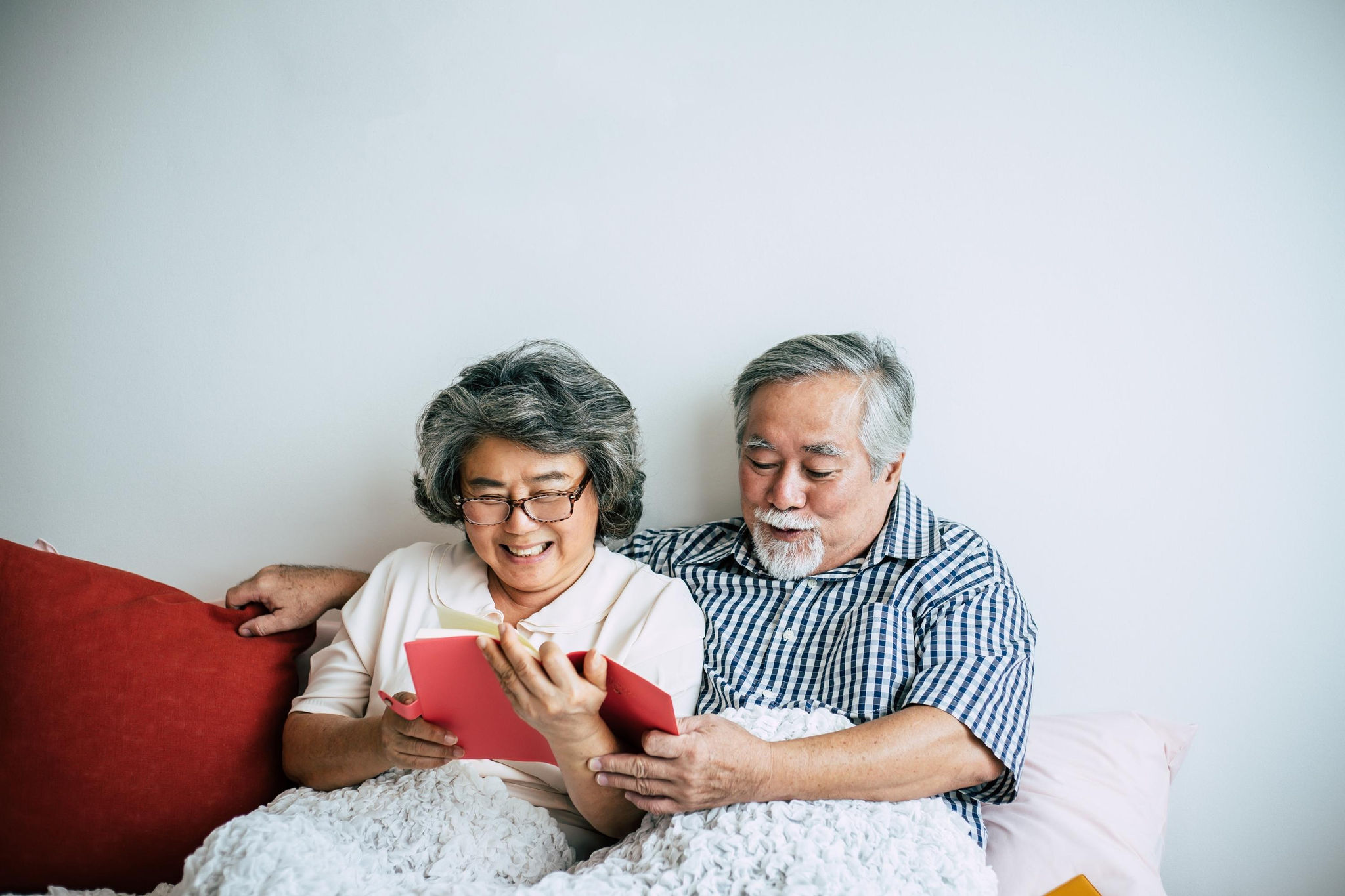 canva-senior-couple-reading-book