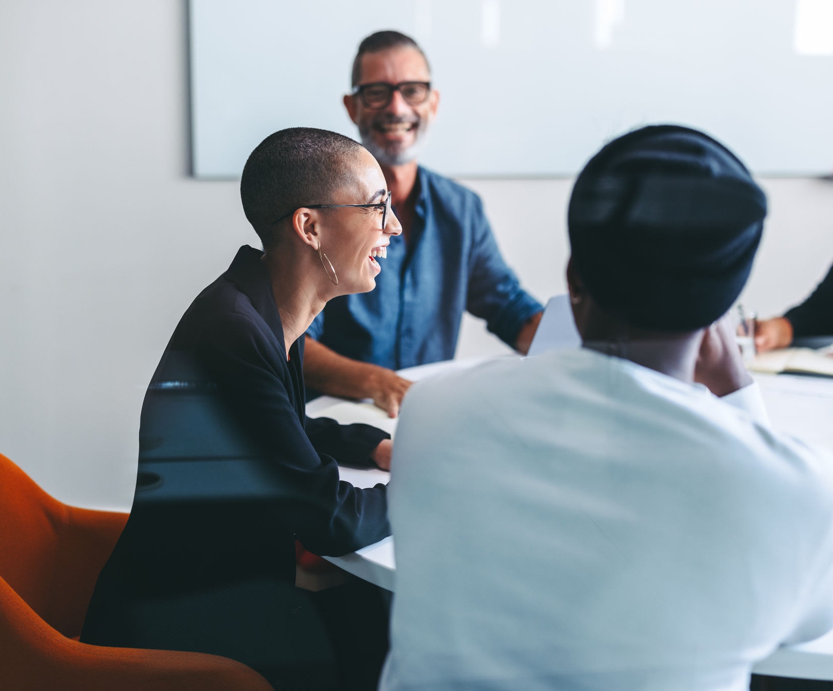Happy businesspeople smiling cheerfully in a meeting room