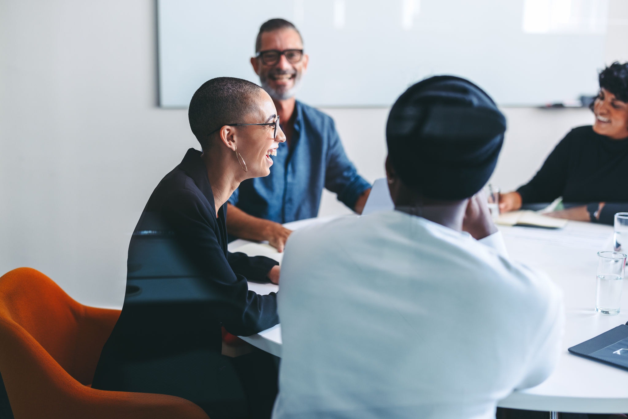 Happy businesspeople smiling cheerfully in a meeting room