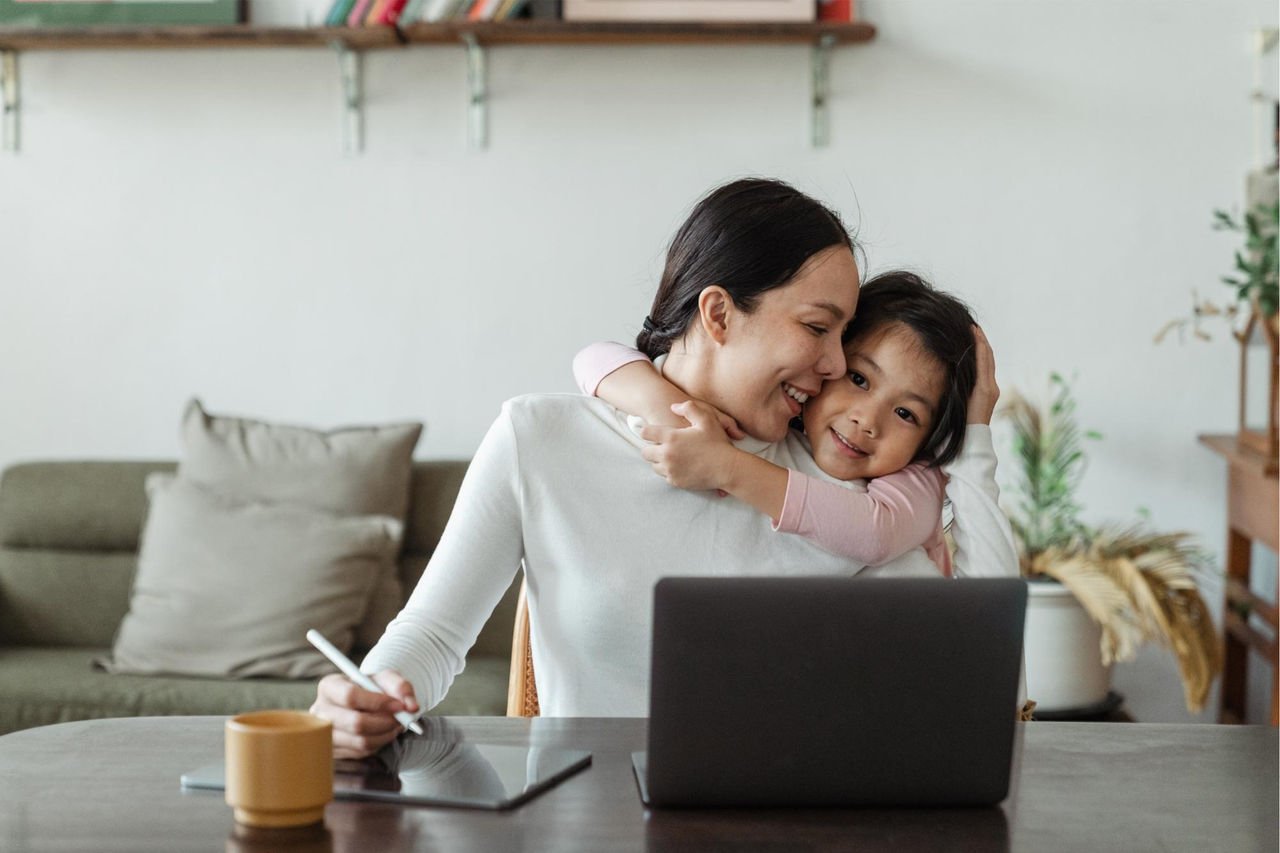 Mother with daughter working at desk