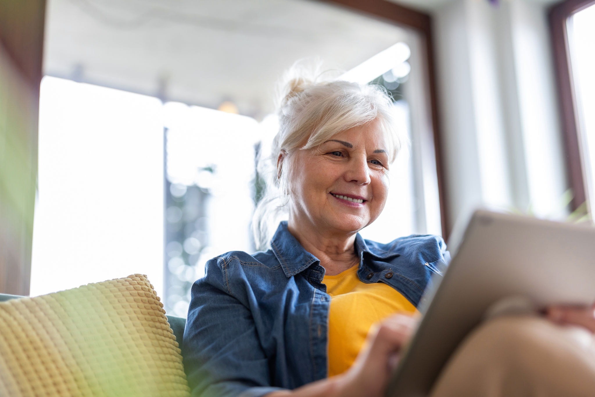 Woman sitting on lounge working on her laptop