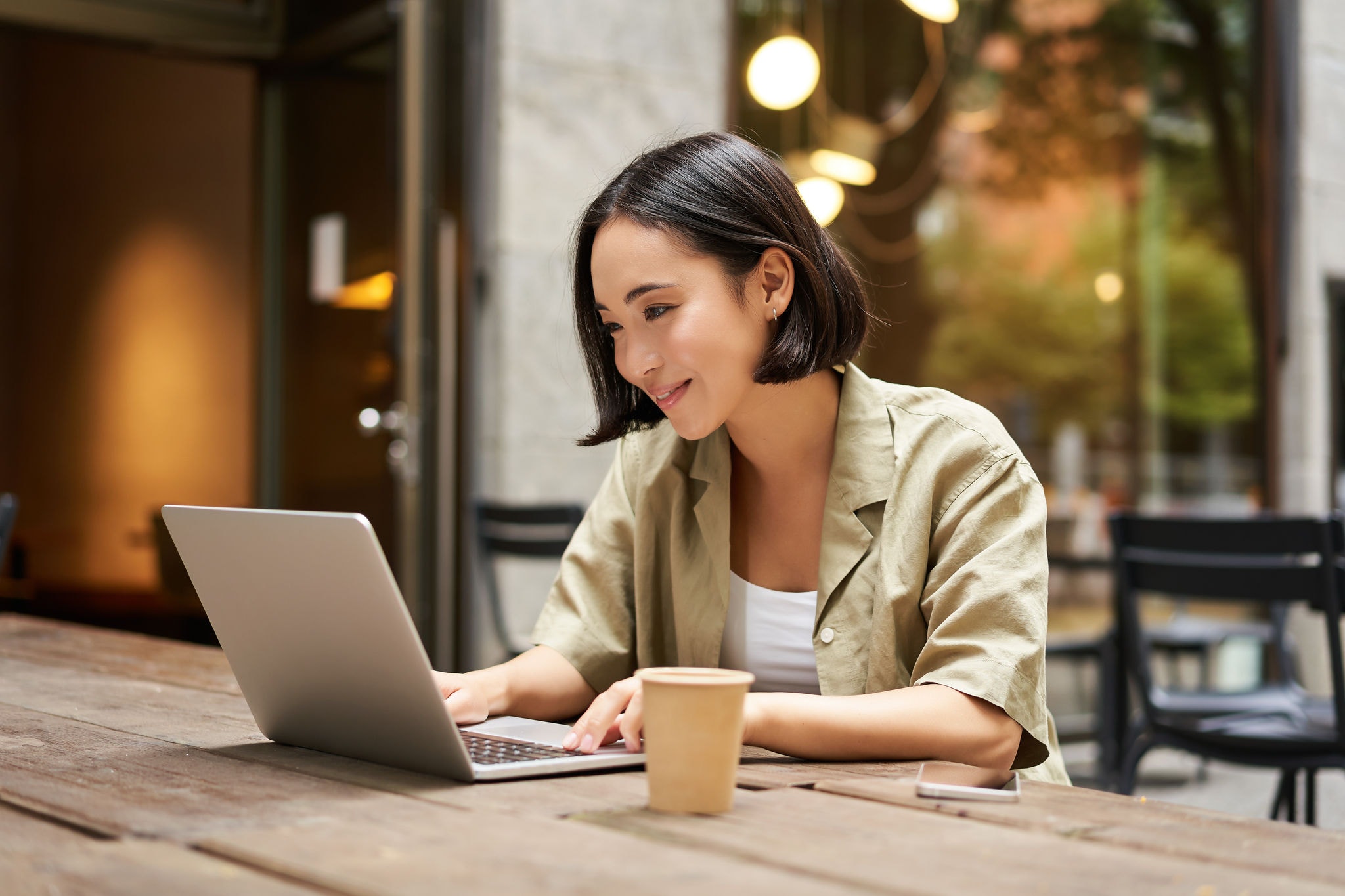 Young woman working remotely from a cafe