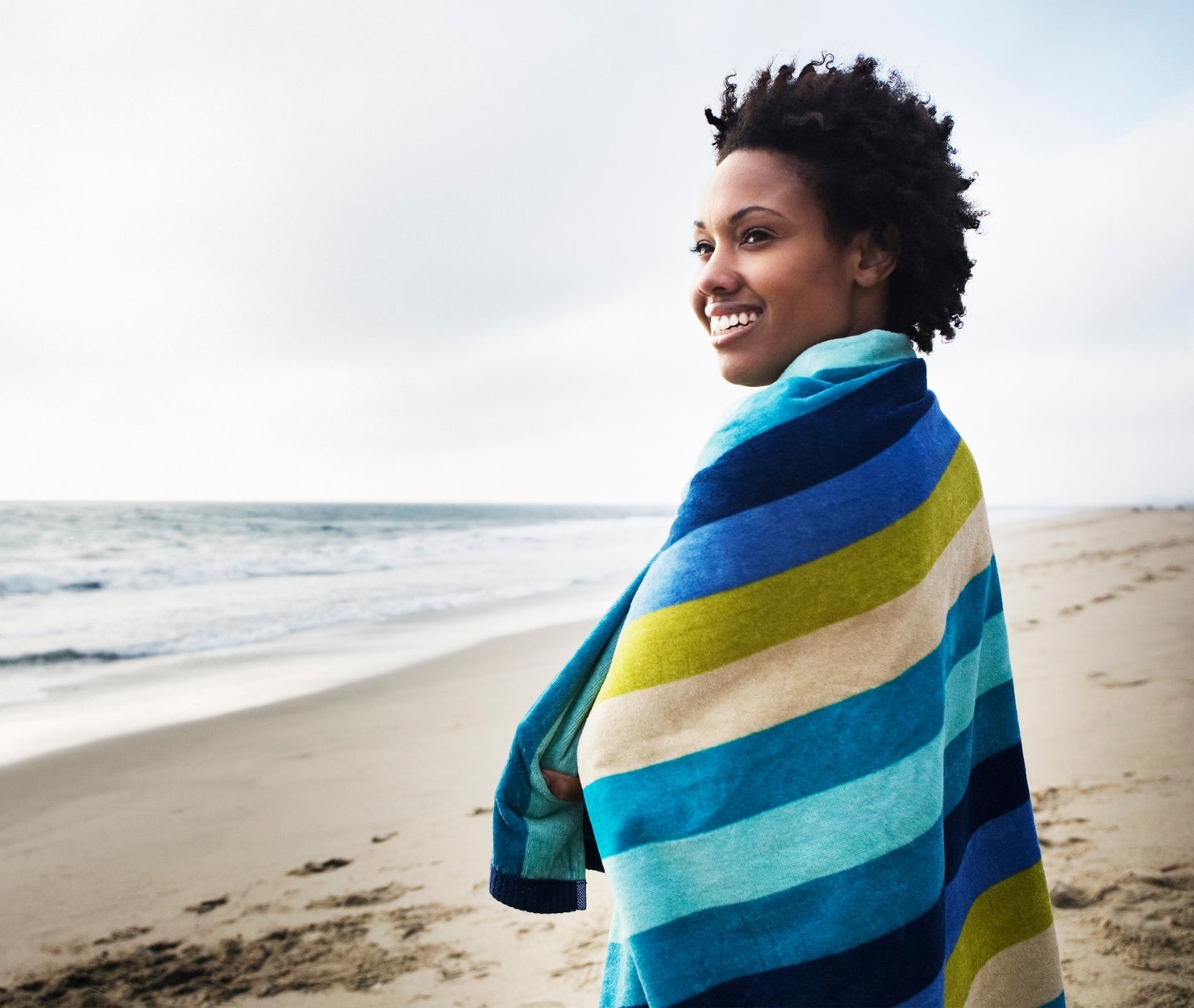 Woman wrapped in towel at the beach