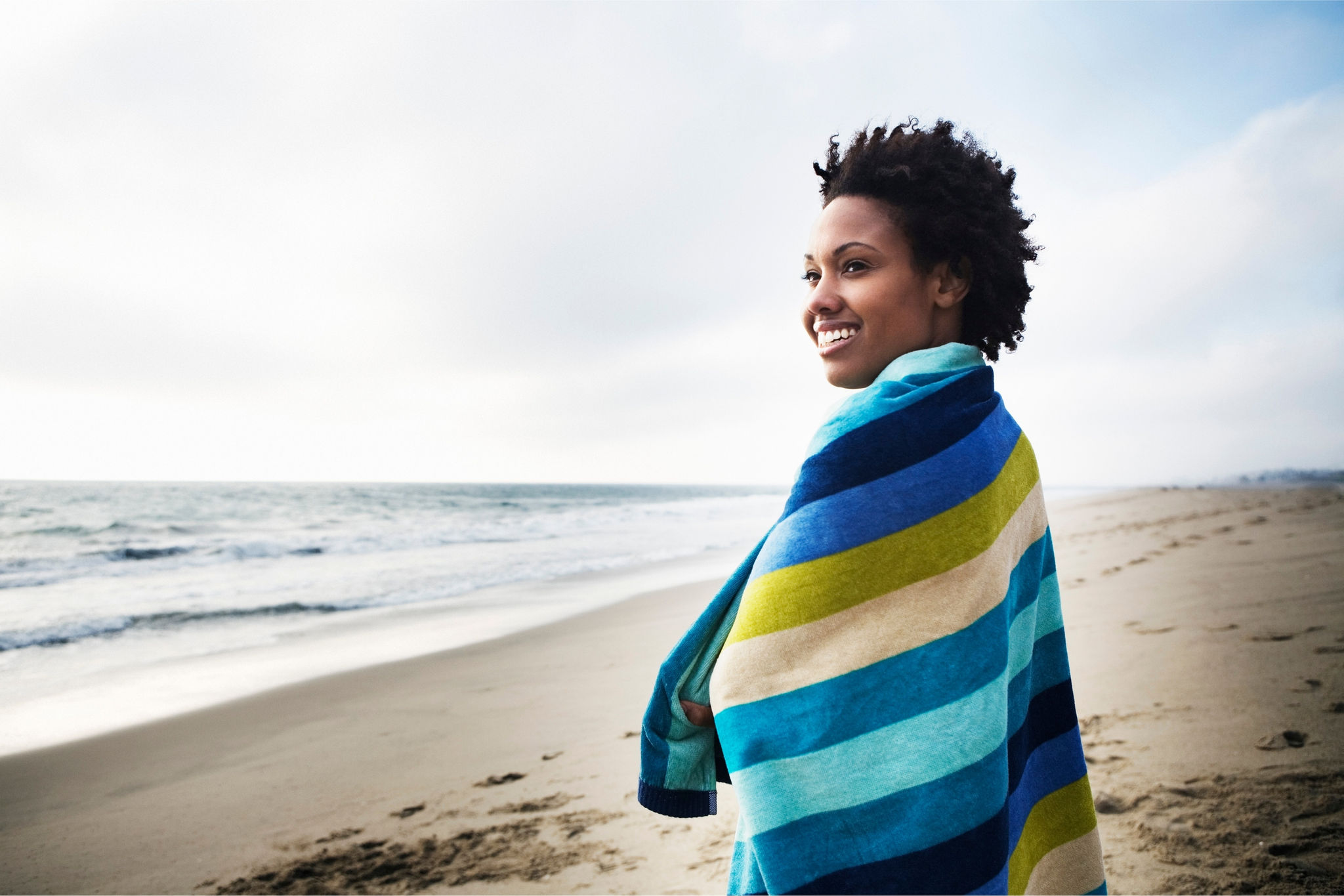 Woman wrapped in towel at the beach