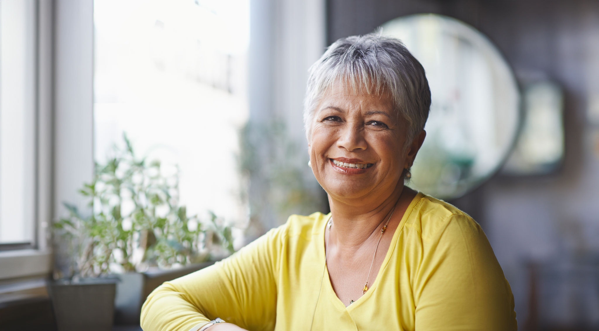 Woman smiling sitting in a coffee shop