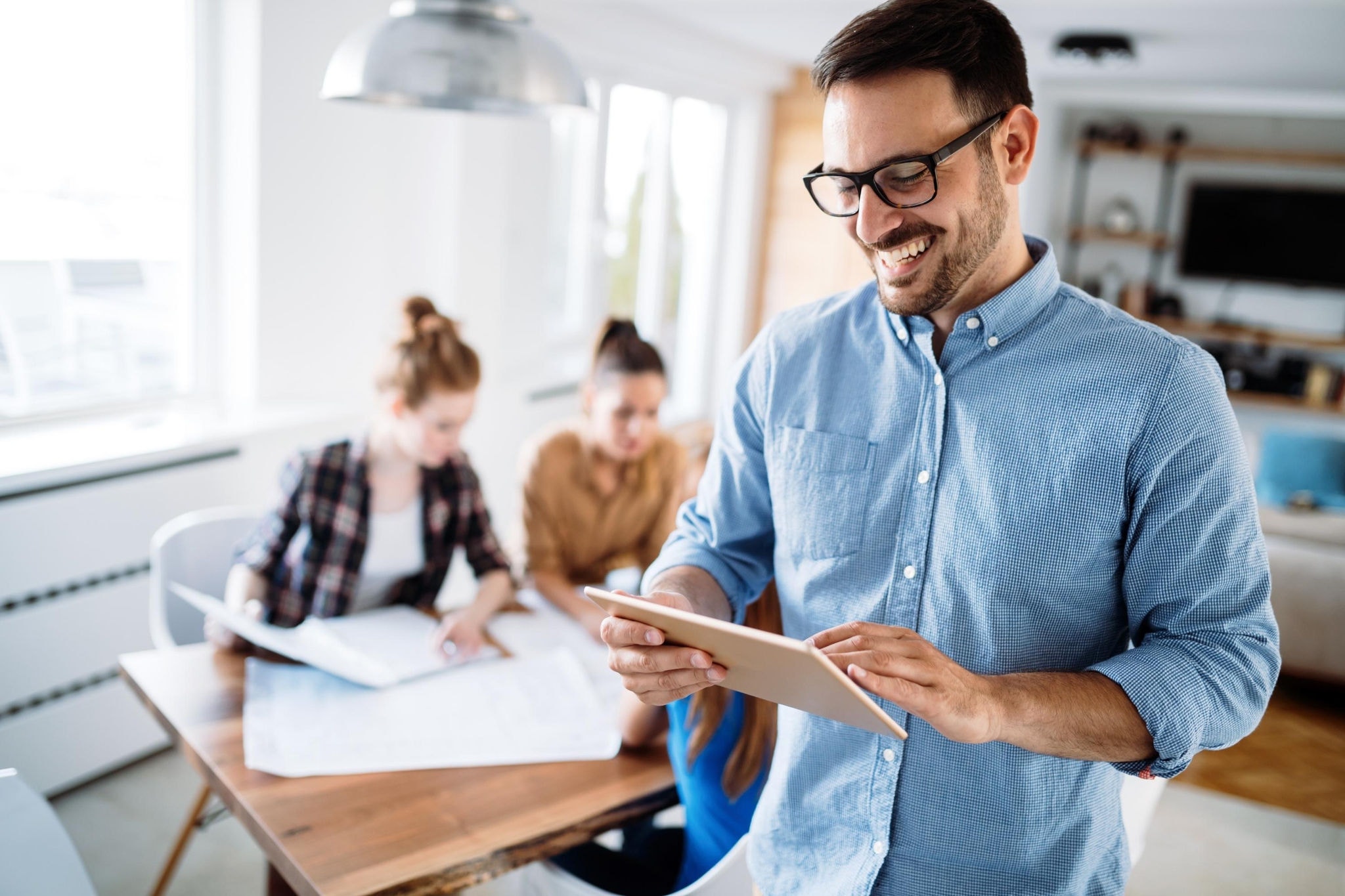 Male manager on his tablet in the office 