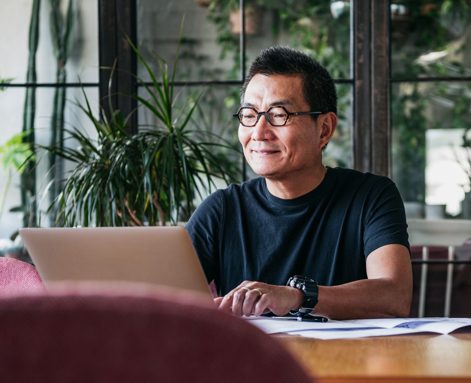 Man working at home typing on his computer 