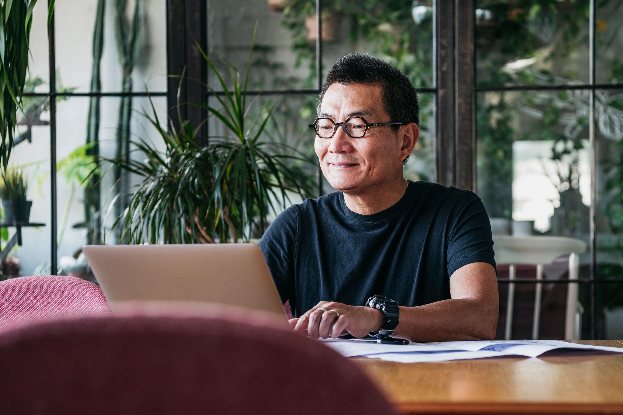 Man working at home typing on his computer 
