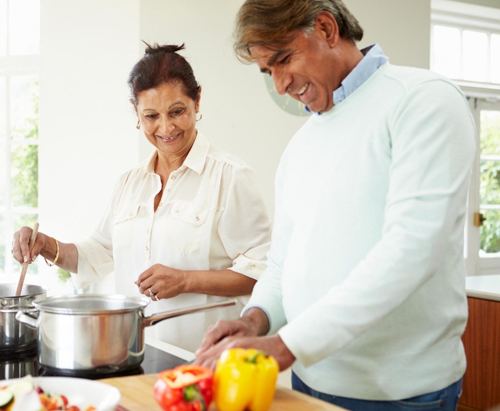 canva-senior-indian-couple-cooking-home