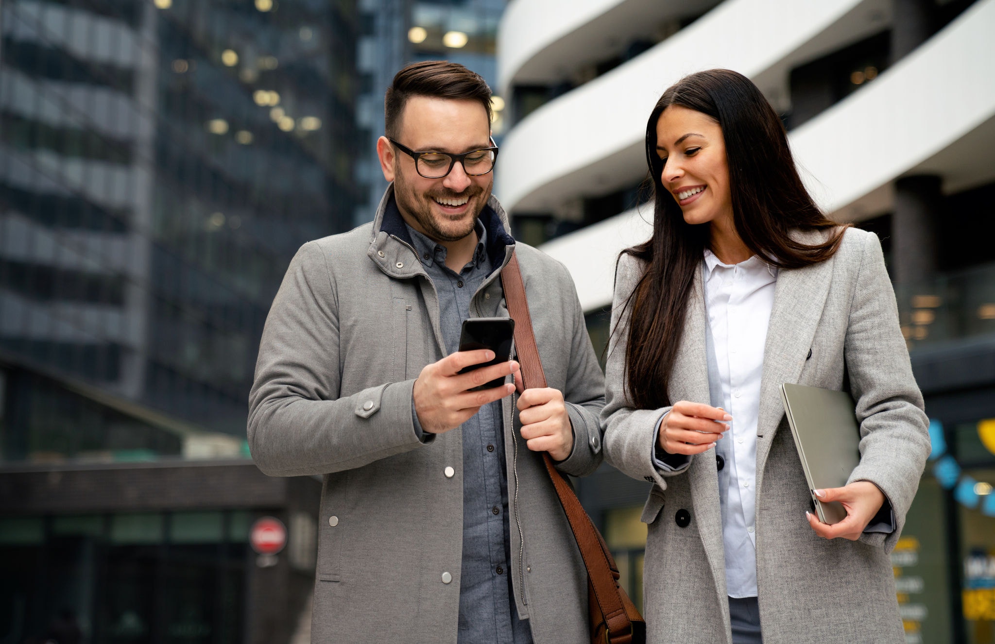 Picture of handsome man and beautiful woman as business partners working talking outdoor