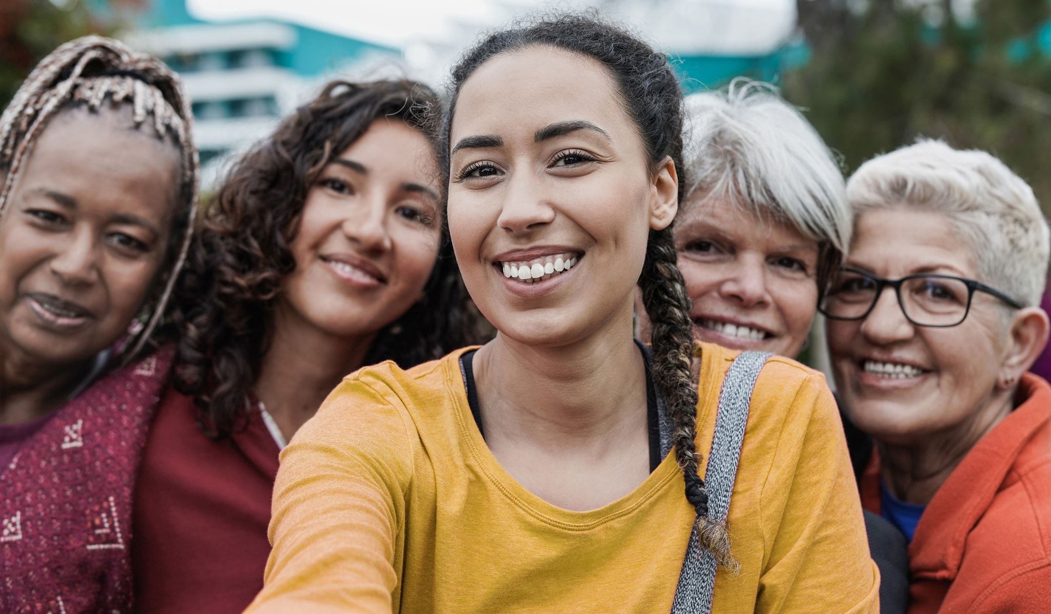 A group of young and mature women smiling