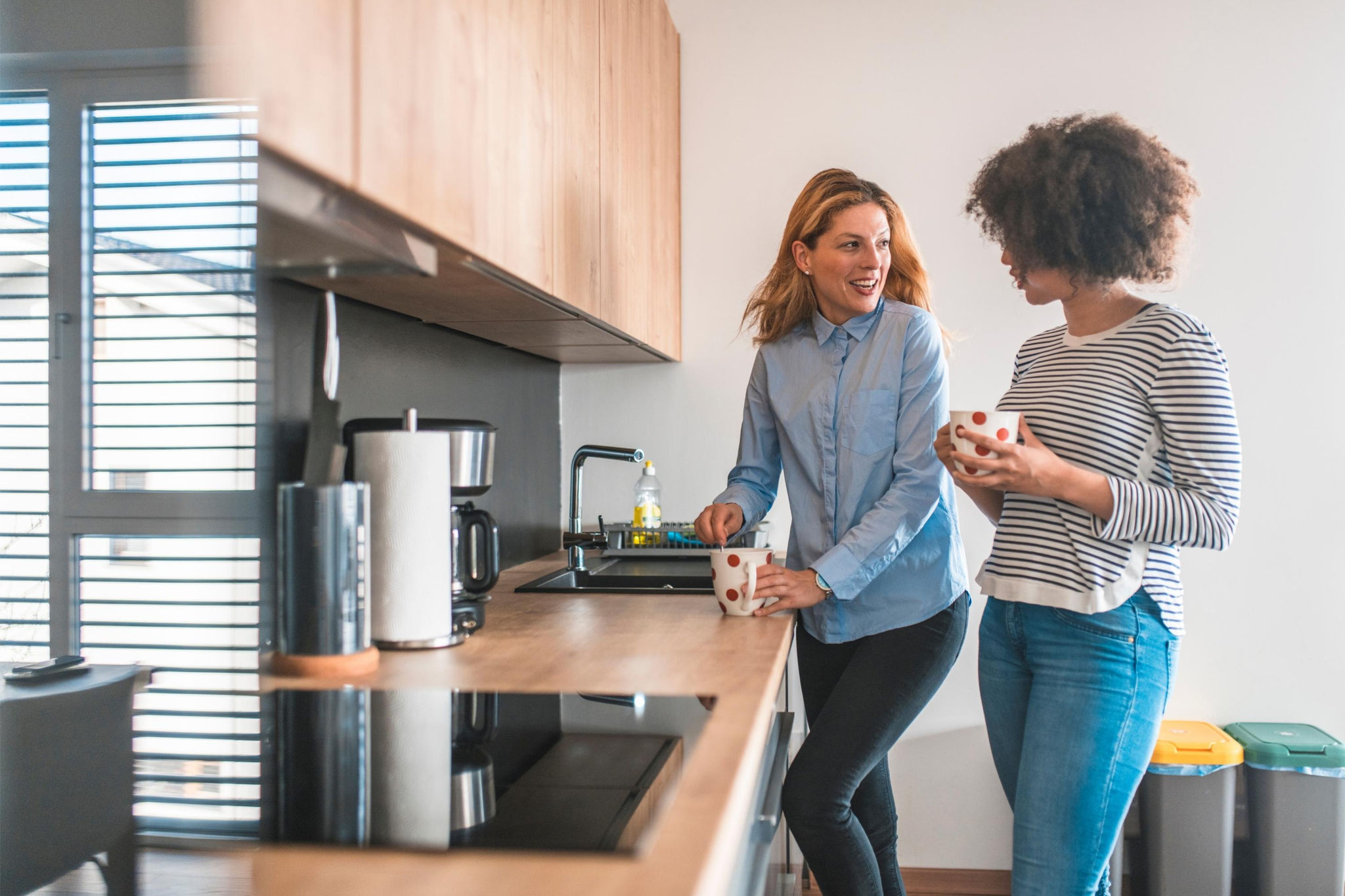 Canva-women-chatting-kitchen-drinks-tea-break