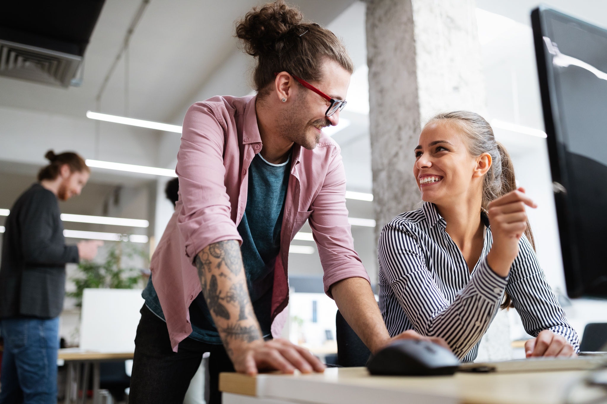 Smiling work colleagues having a discussion
