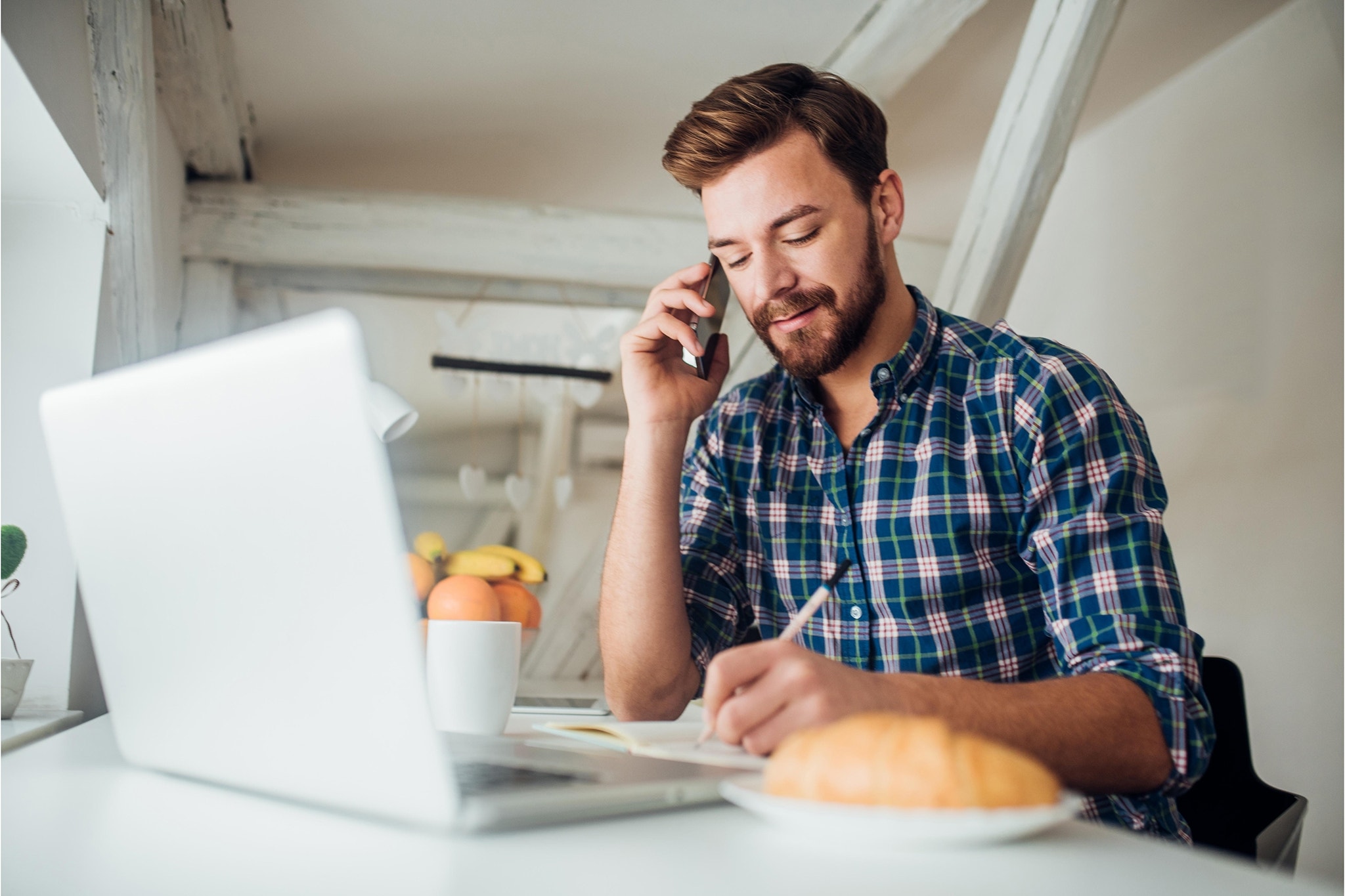 canva-man-writing-phone-laptop