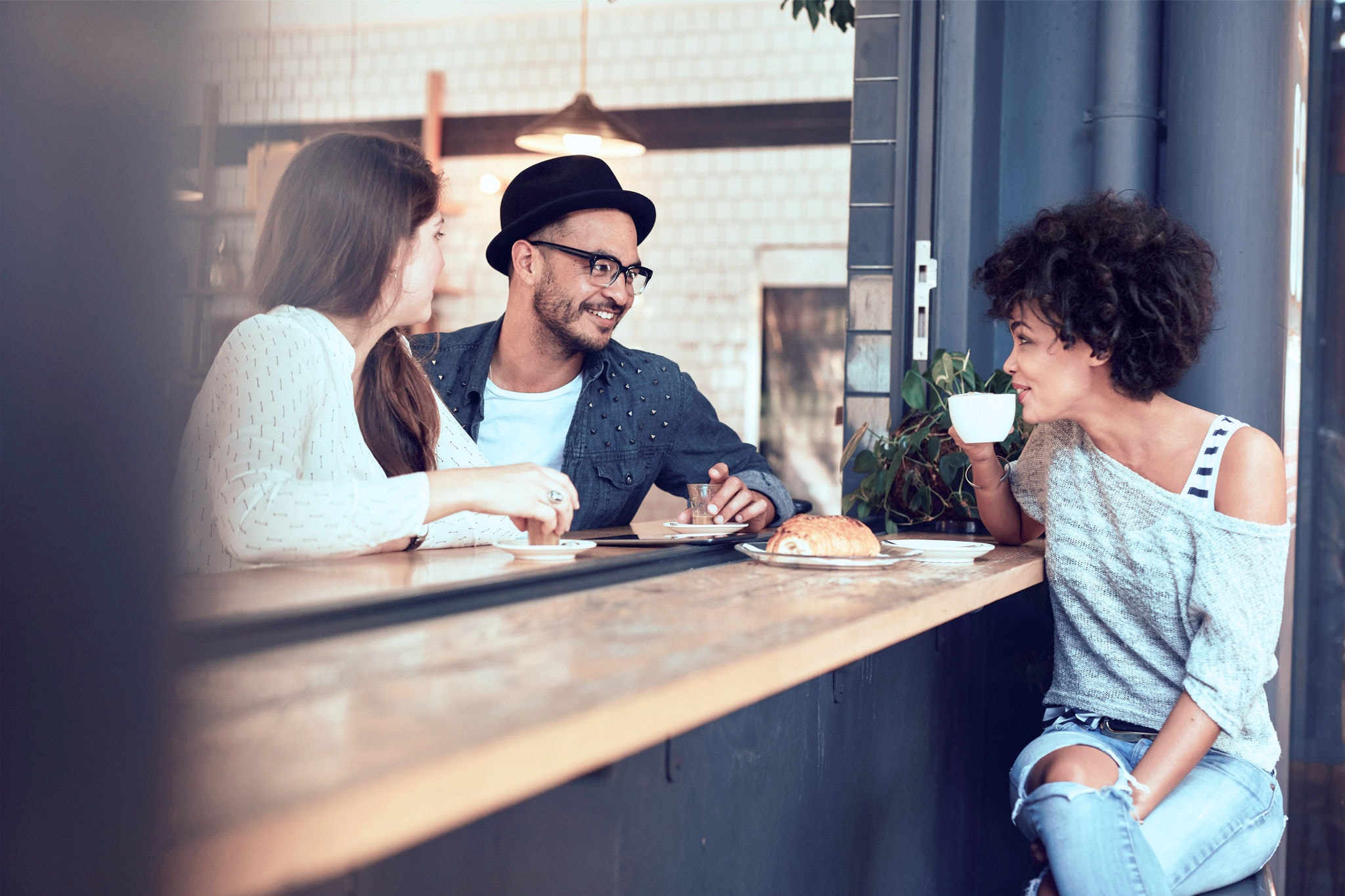 Group of friends sitting and chatting at a cafe