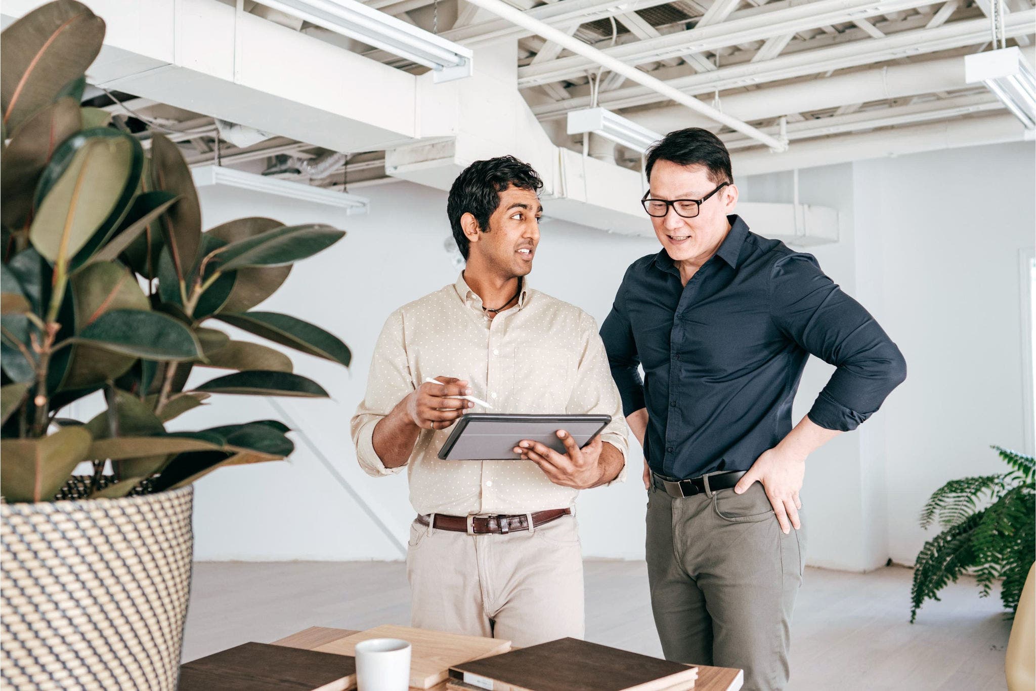 Co-workers standing in the office with a tablet
