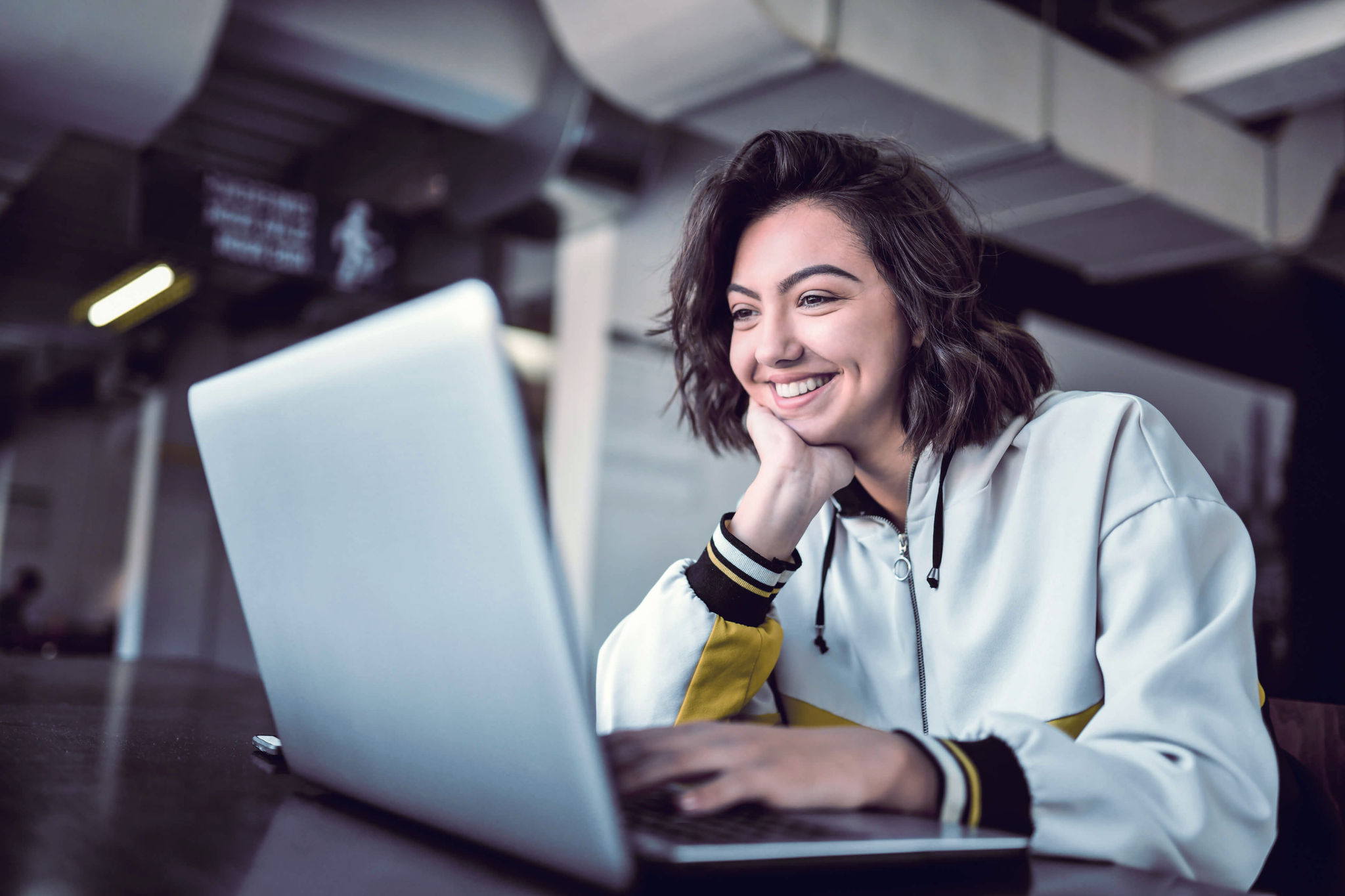 Young female on her laptop smiling