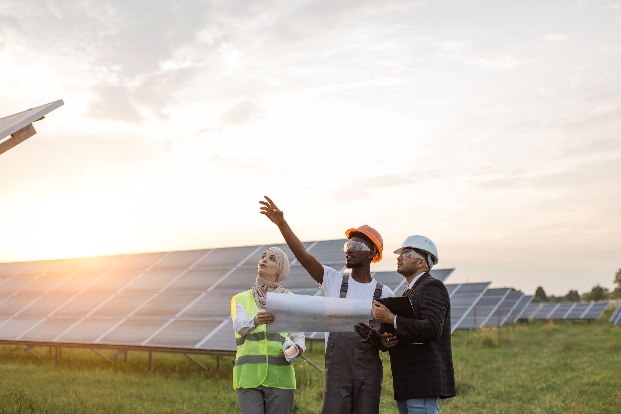 A group of workers discussing at a solar station