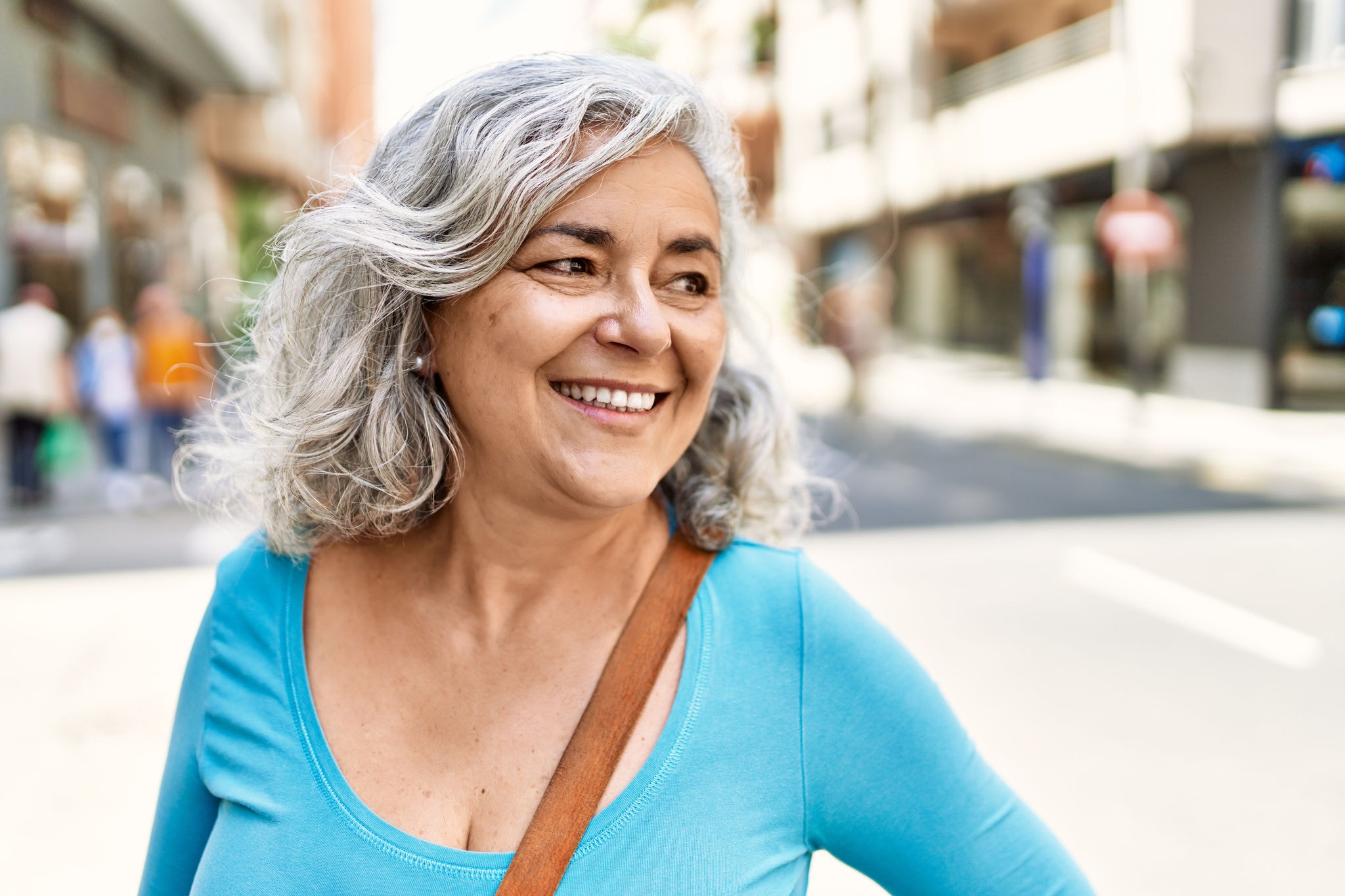 Happy woman enjoying shopping in the city
