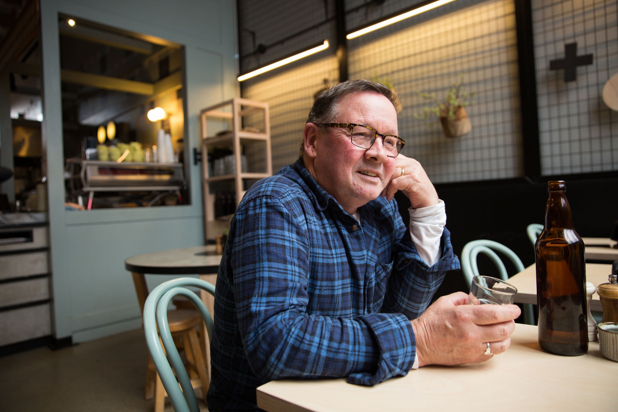 Close up of a man sitting at a table in a coffee shop
