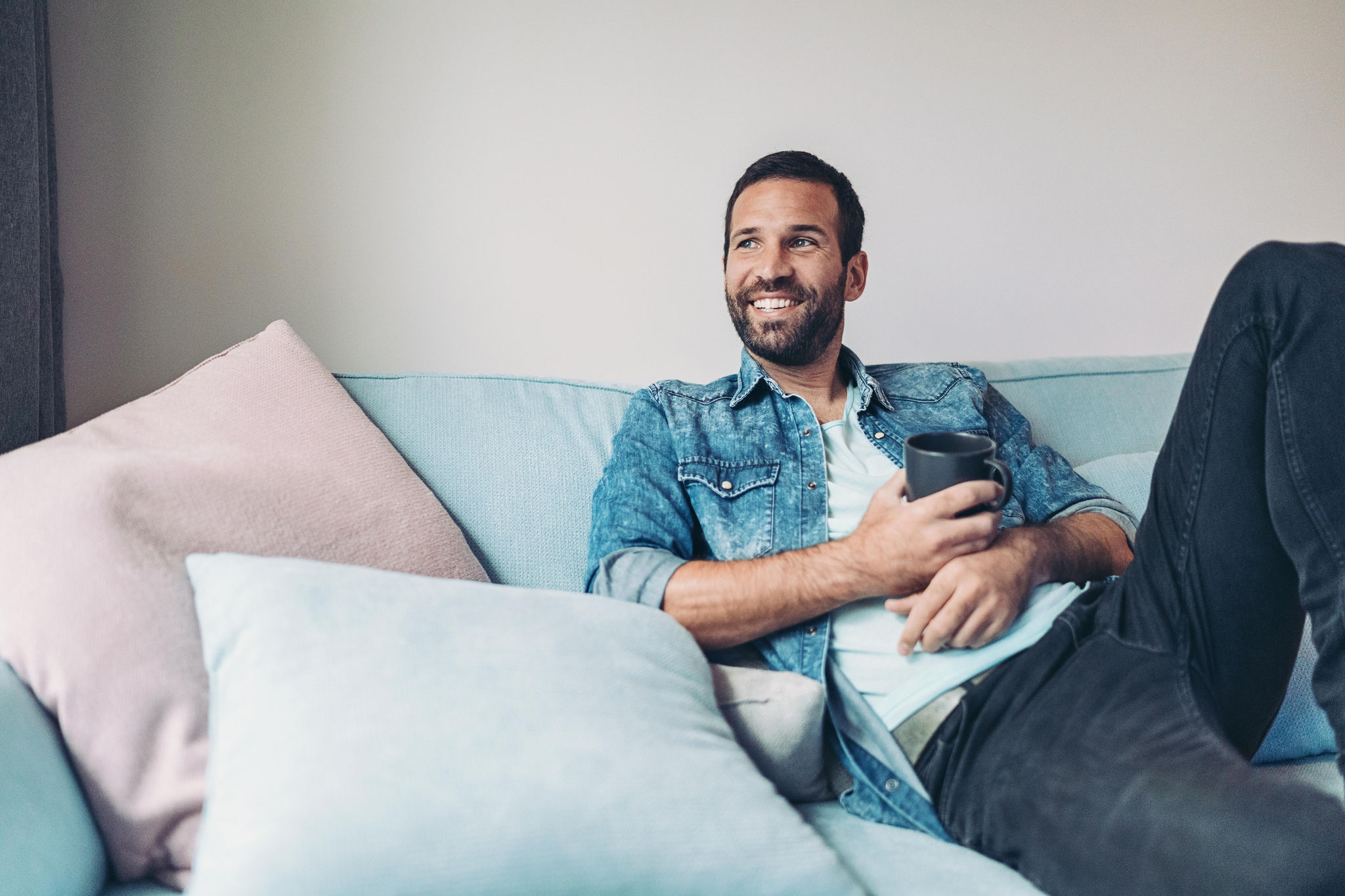 Man relaxing on the couch having a coffee
