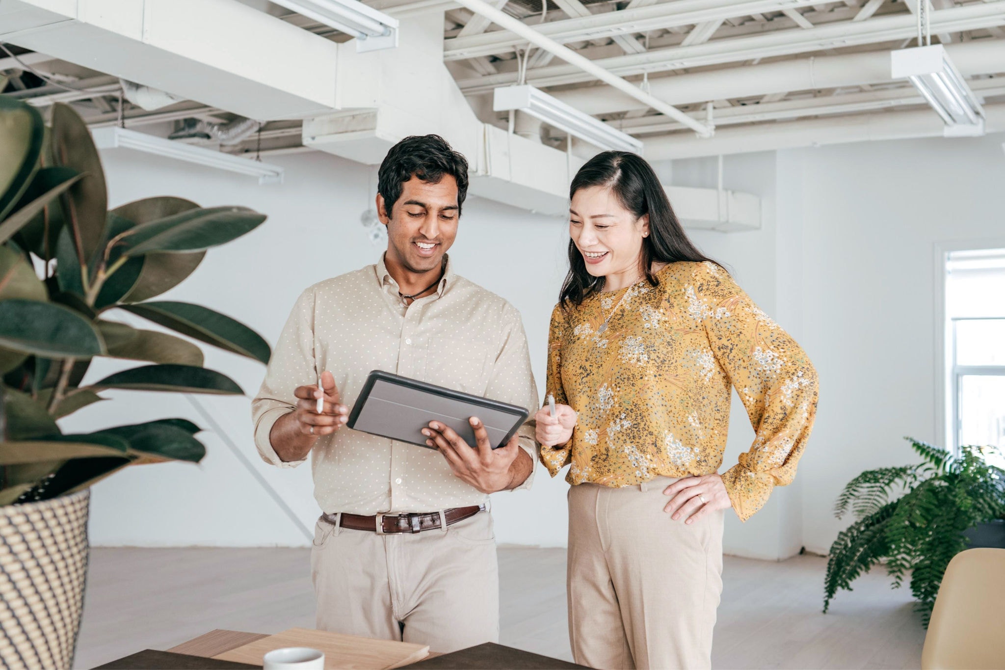 canva-diverse-colleagues-office-standing-discussing