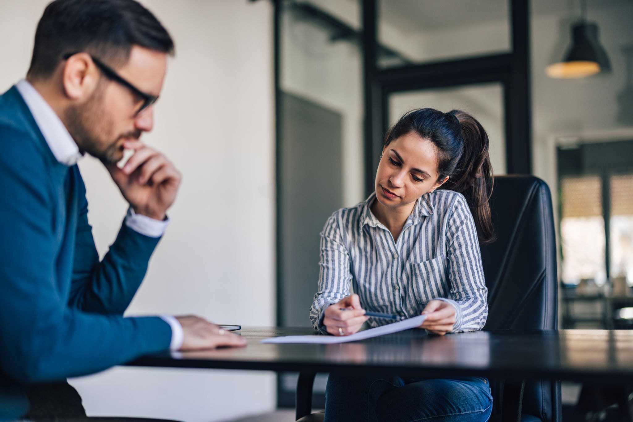Business woman showing a document to her boss