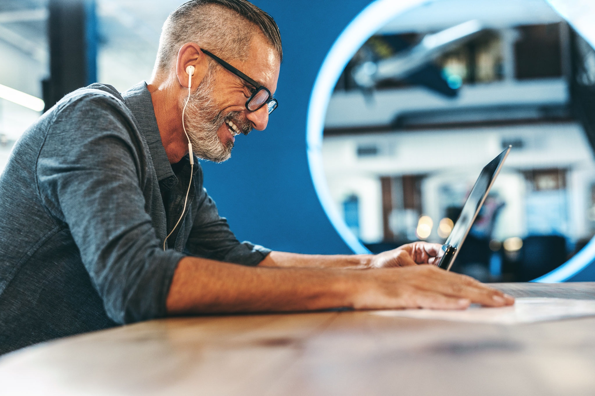 Smiling businessman attending a virtual meeting at work