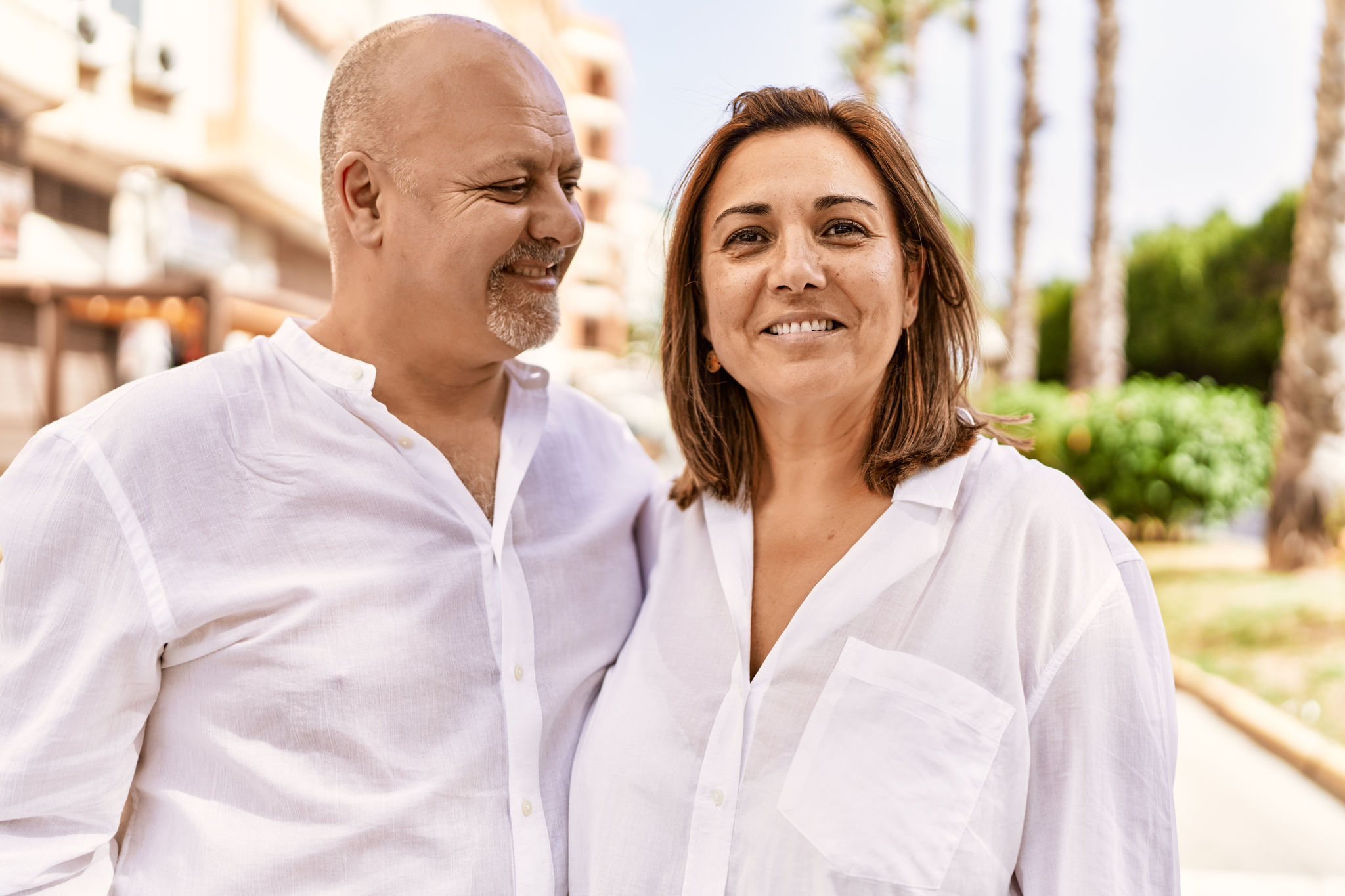 A man and woman sitting together looking at a phone.