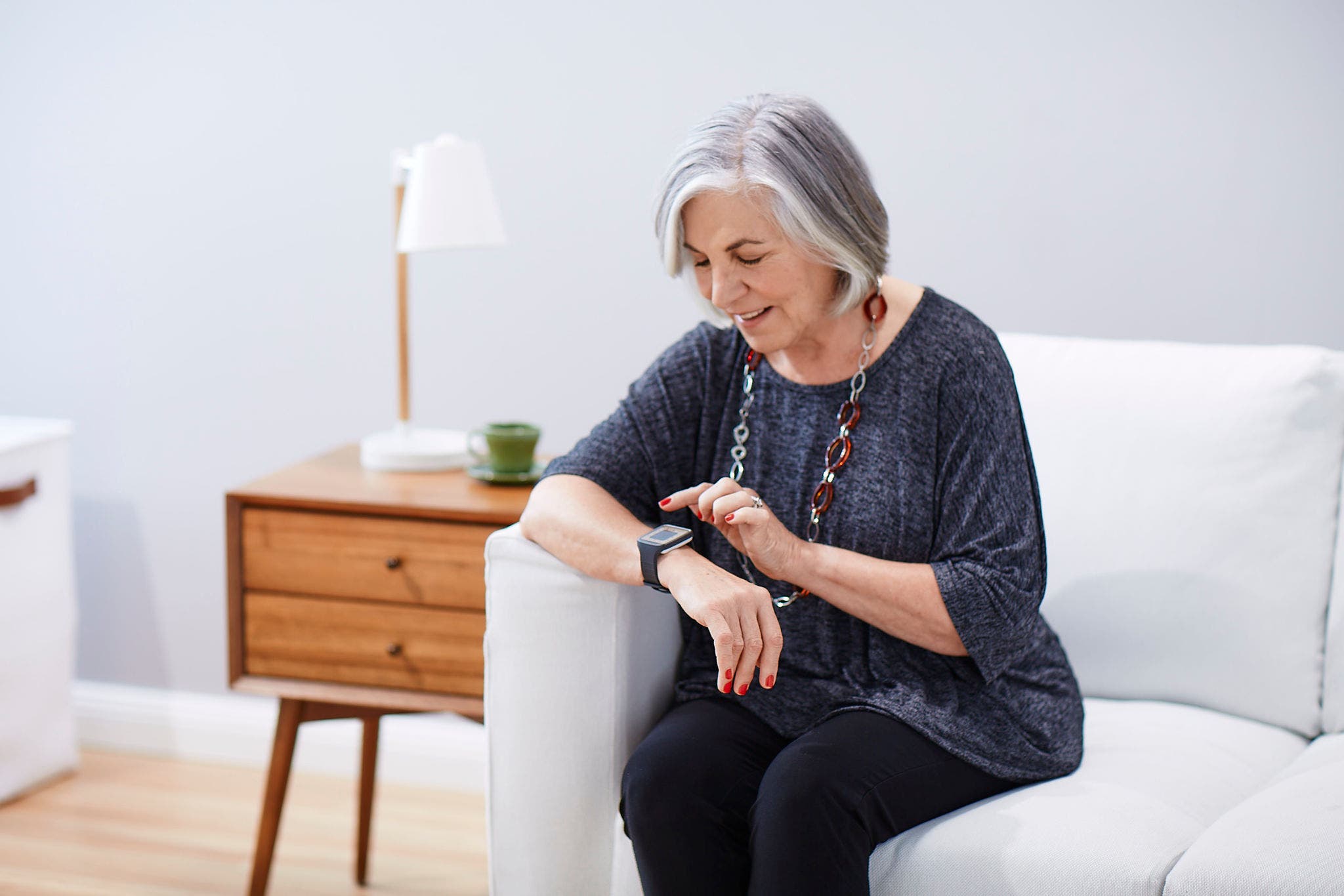 Senior woman checking the time on her watch